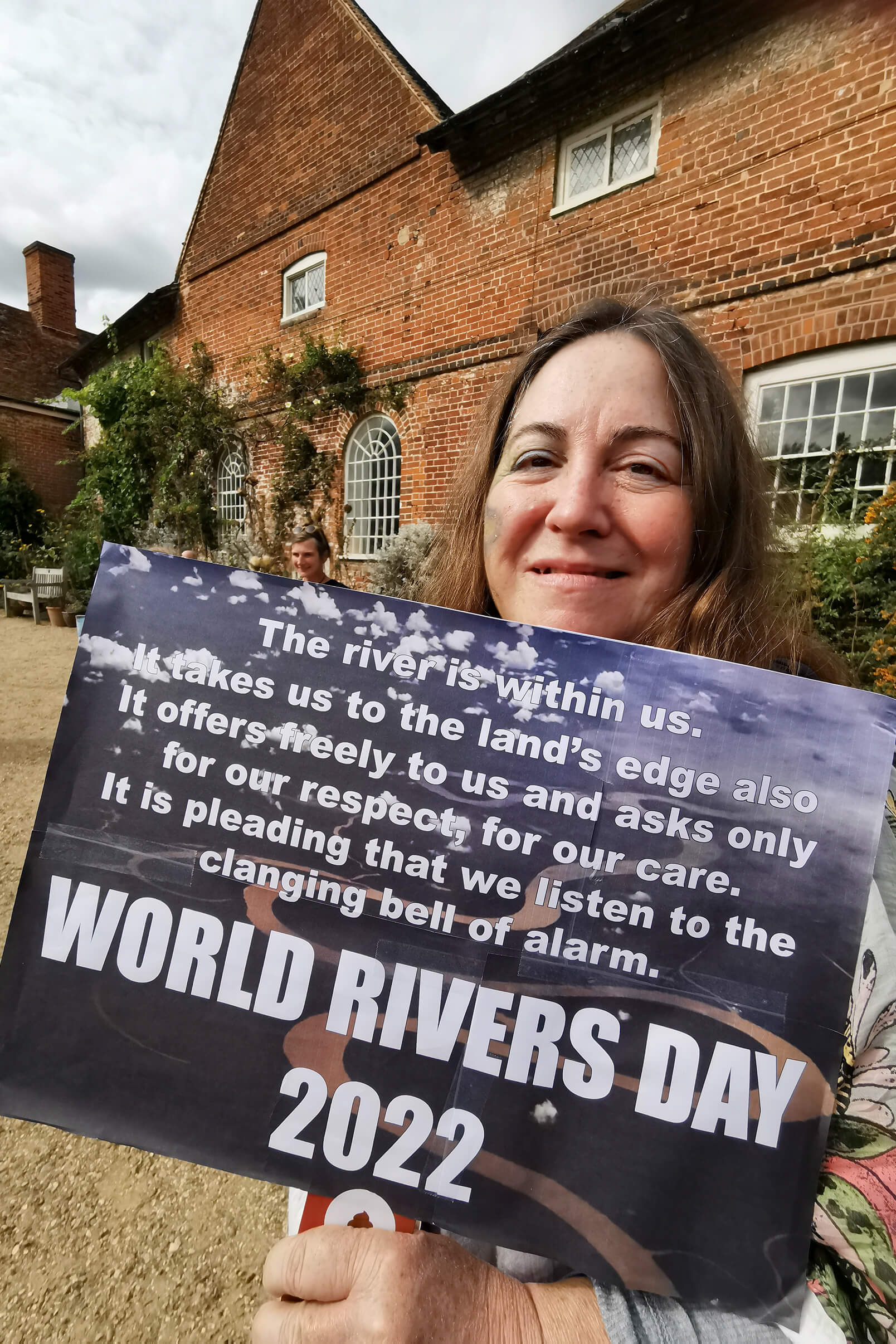 Protester holds up World Rivers Day sign