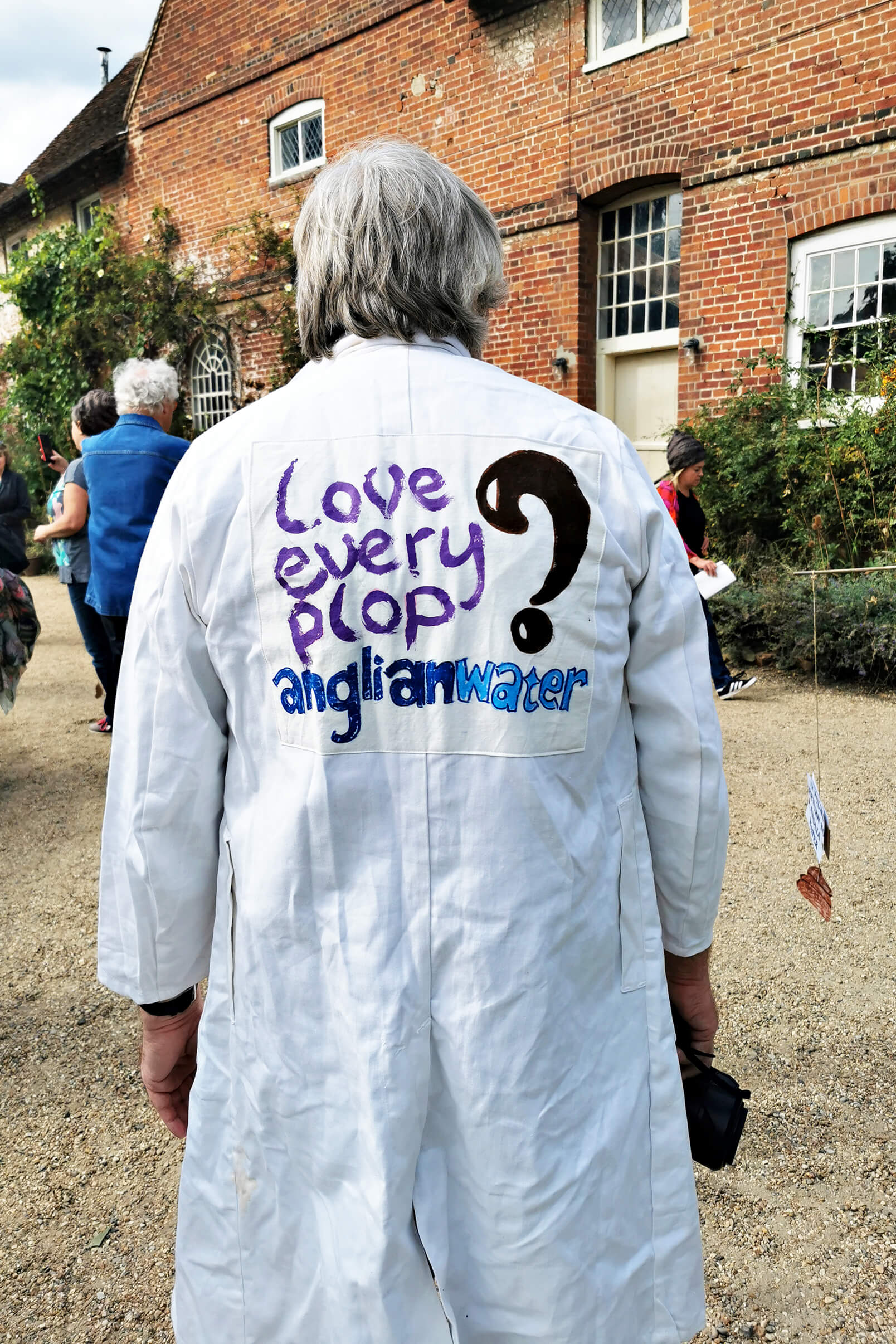 The back of a protesters white laboratory coat